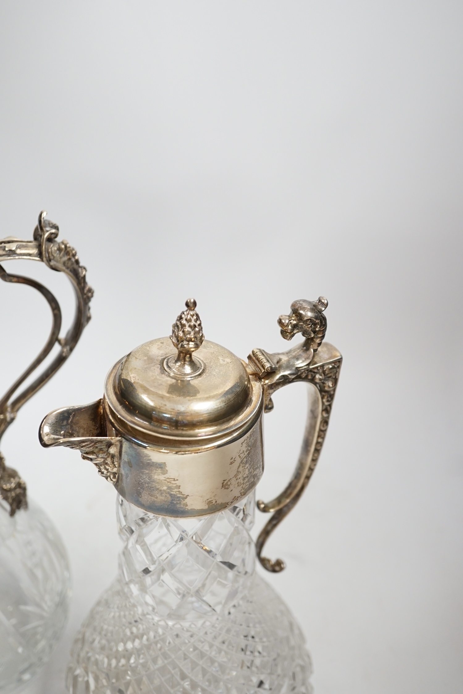 A 1970's silver mounted cut glass baluster claret jug, 31.3cm and one other 800 standard white metal mounted cut glass claret jug.